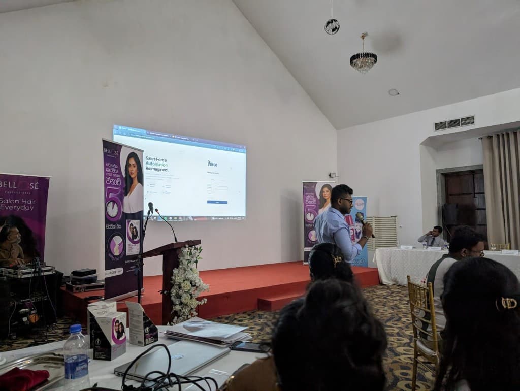 Presenter introducing the iForce sales force automation platform at a Bellose event